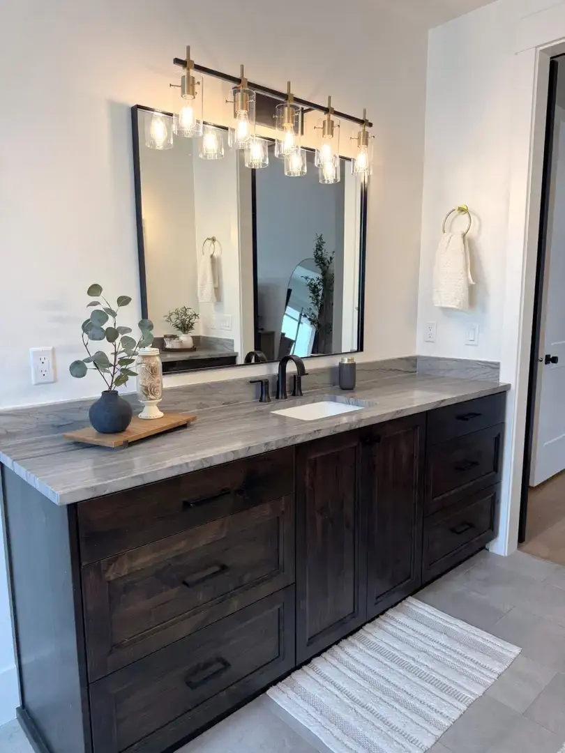 Dark wood vanity with marble countertop in a Slaterville, Utah bathroom.