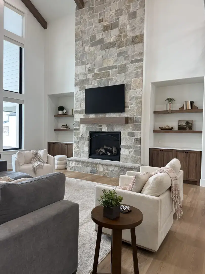 The Olsen Project living room with stone fireplace and custom home cabinetry in Slaterville, Utah.